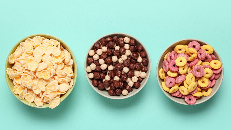 three bowls of different types of cereal on display