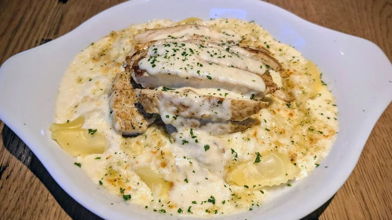 Chicken Tortelloni Alfredo in a white bowl with sauce and cheese served at Olive Garden