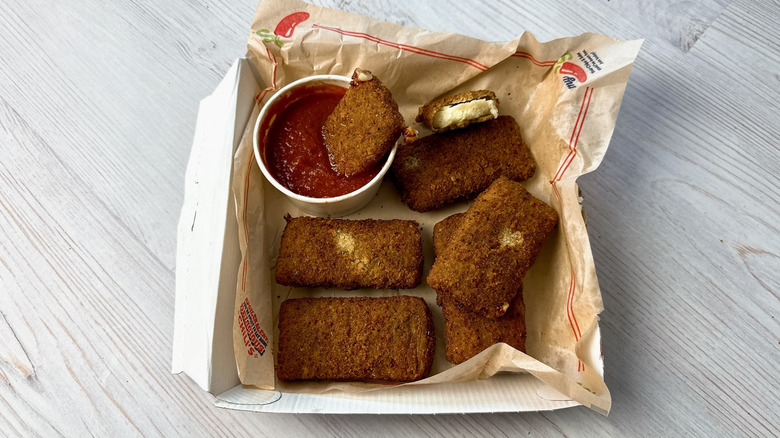 Chili's fried mozzarella in a takeout container with marinara sauce
