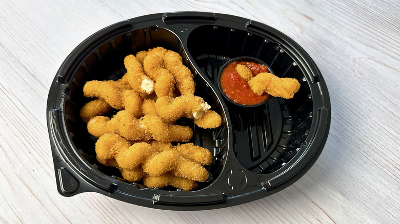 Red Robin mozzarella twists in a to go box with marinara dipping sauce