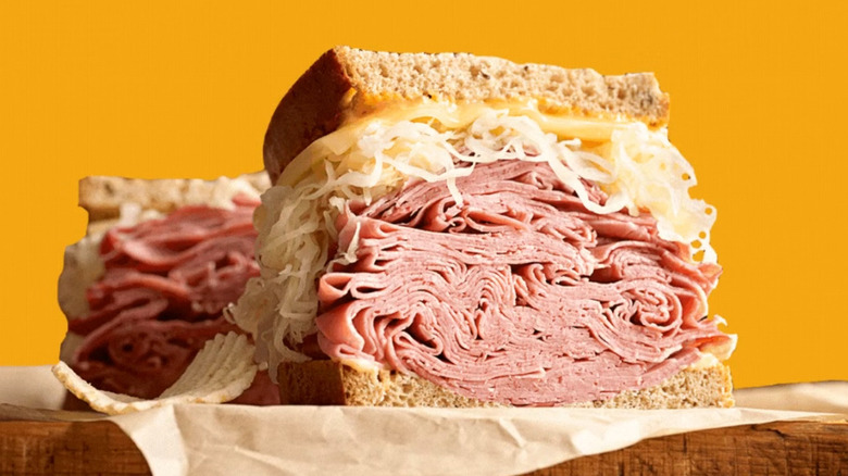 A sandwich piled high with meat and sauerkraut