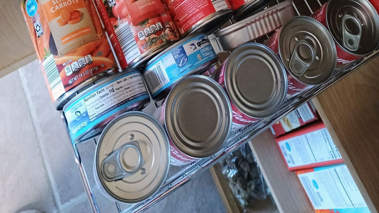 A pantry draw with tins of food