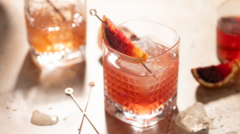a low ABV cocktail in a rocks glass with an orange garnish
