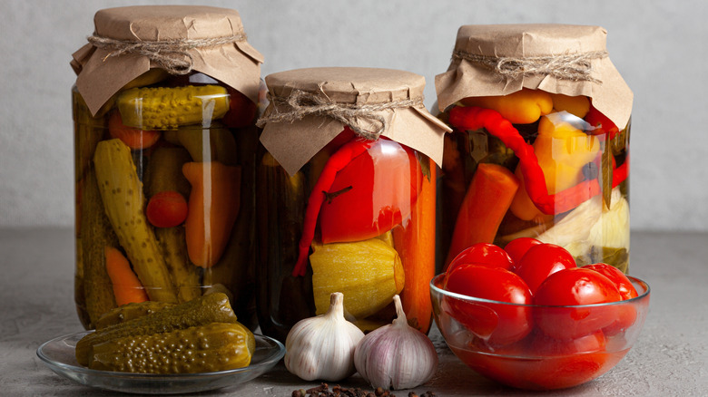 three jars of pickled vegetables