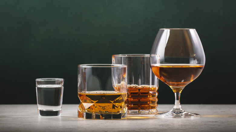 tequila, mezcal and rye whiskey in glasses on a bar