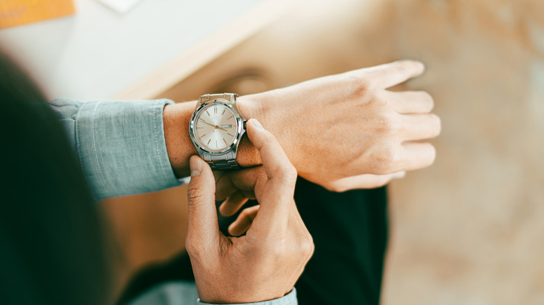 Close up of person checking watch