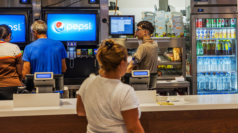 Close up view of Burger King counter with customers ordering food
