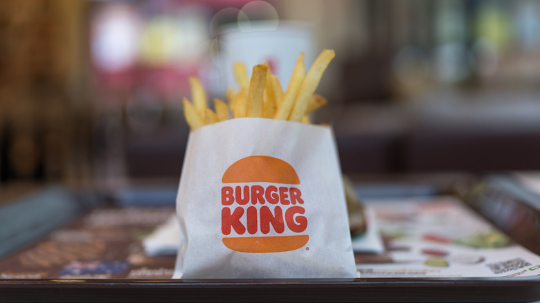 French fries in Burger King package with blurred background