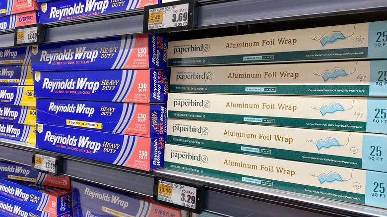 Boxes of aluminum foil on store shelf including Reynolds Warp and Paperbird brands