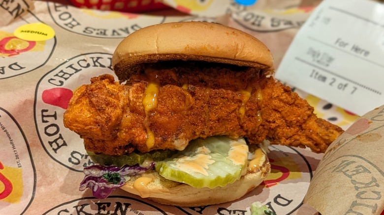 A lightly-seasoned hot chicken sandwich on Dave's Hot Chicken-branded paper