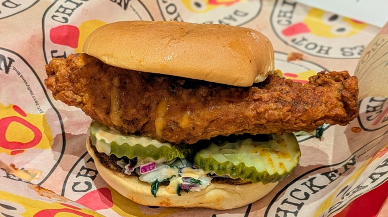 A lightly-seasoned fried chicken sandwich on Dave's Hot Chicken-branded paper