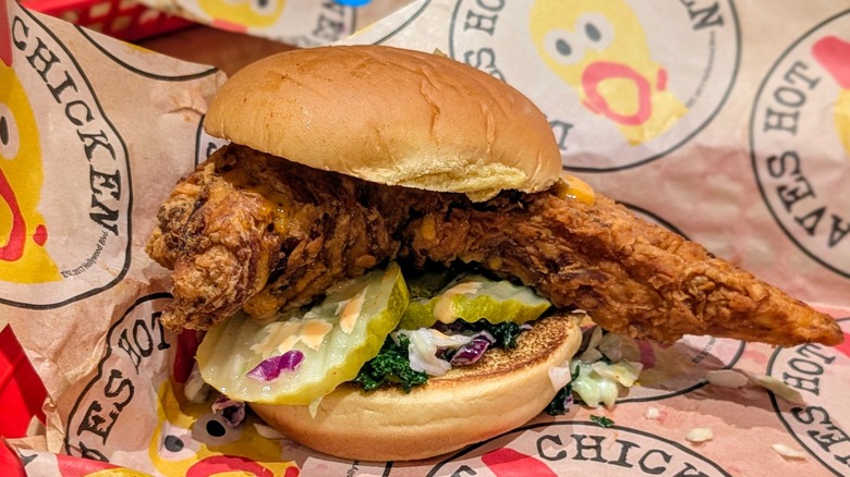An unseasoned fried chicken sandwich on Dave's Hot Chicken-branded paper