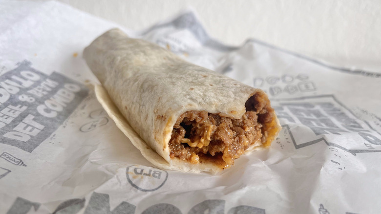 Beef & Cheddar Burrito on paper wrapper