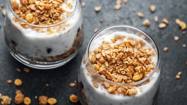 yogurt parfait with granola on a black surface