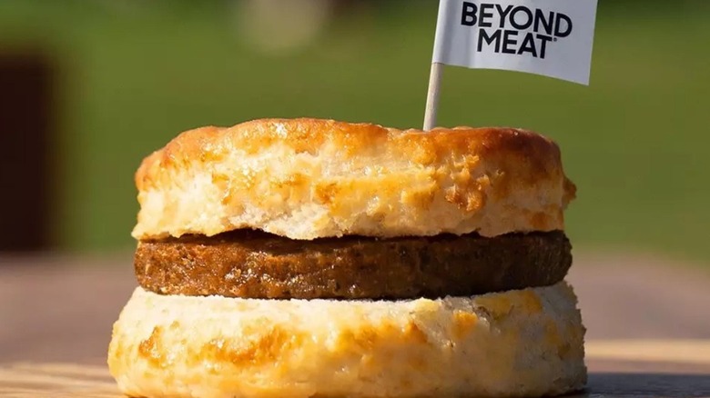 A Hardee's breakfast sandwich with a flag that says "Beyond Meat" stuck in it