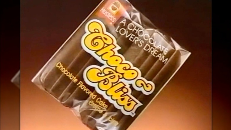 A package of two chocolate-frosted cakes over a brown gradient background reading "Choco Bliss; A chocolate lover's dream"