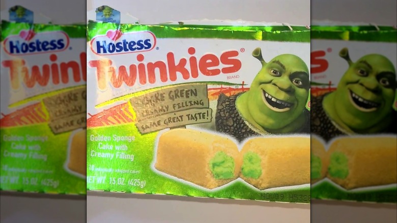 A luminescent box of Shrek promotional Twinkies featuring an image the green-filled snack cake alongside a smiling ogre