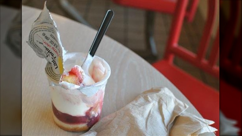 KFC Little Bucket parfait with spoon inside on wooden table
