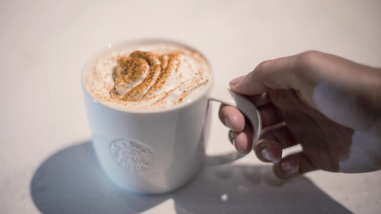 Chile mocha viewed from above with cocoa, chocolate, and red chiles