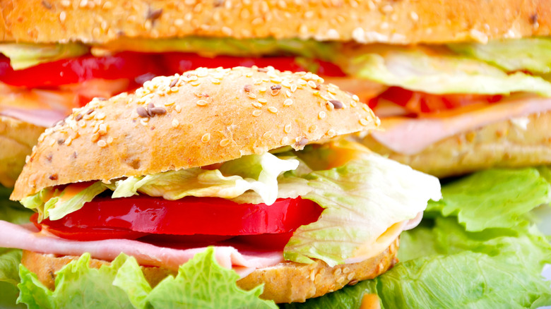 close up of round ham salad sandwich with sandwich background