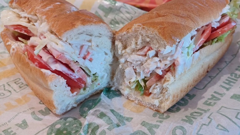 Close up of two halves of Seafood Sensation sandwich on Subway wrapper