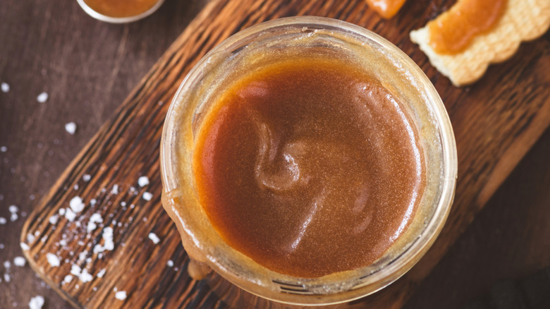homemade caramel in bowl on wooden board