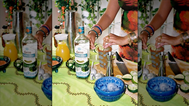 Bartender making a drink with glass bottle of Jose Cuervo on the bar