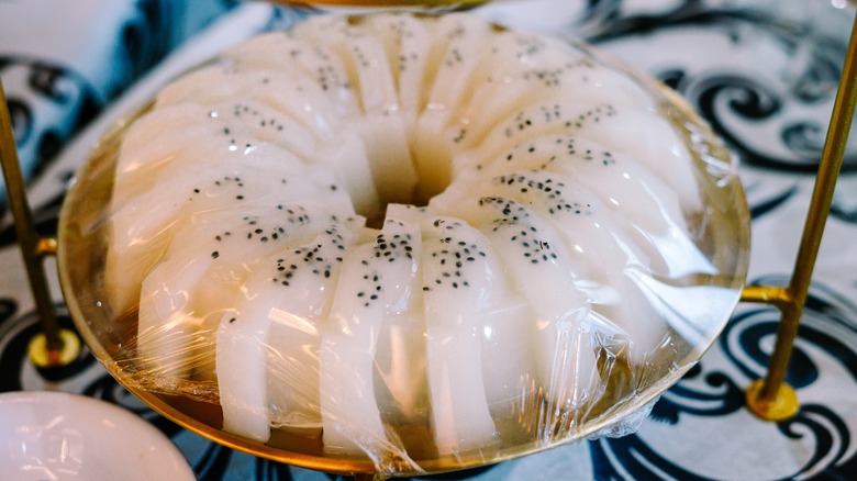 Sliced soursop pudding covered in plastic wrap