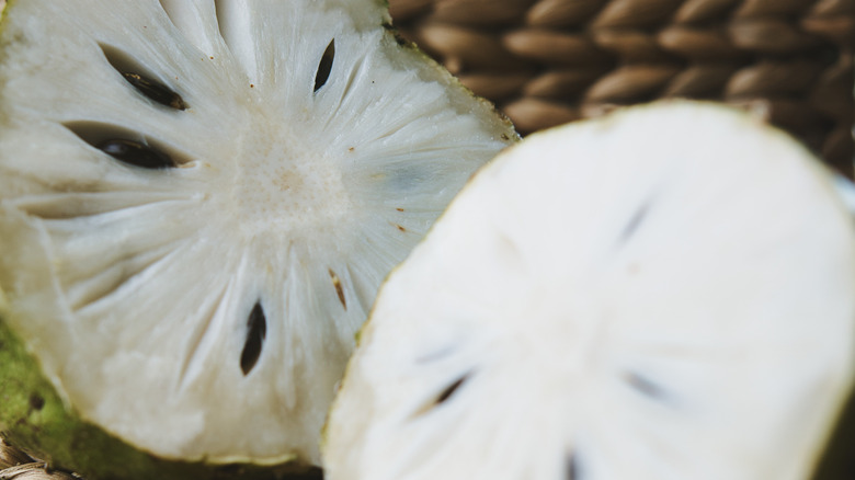 Close-up of halved soursop with black seeds