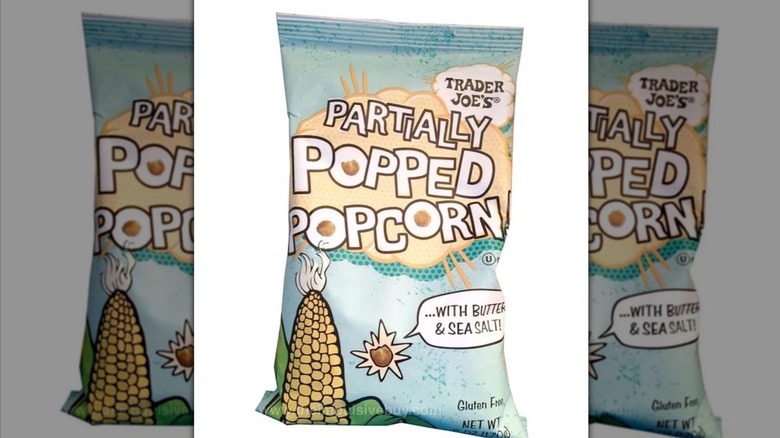 A light blue snack bag with the label "Trader Joe's Partially Popped Popcorn," and a cartoon illustration of an ear of corn.