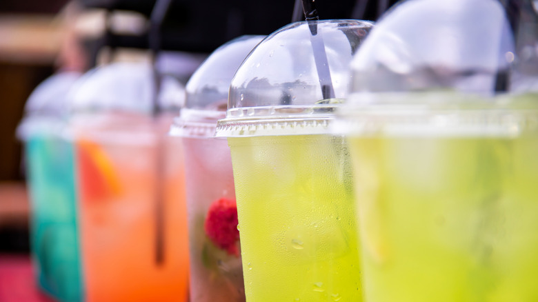 Close up of colorful summer beverages in to-go cups.