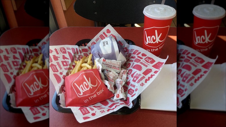A Jack in the Box burger with fries in a basket