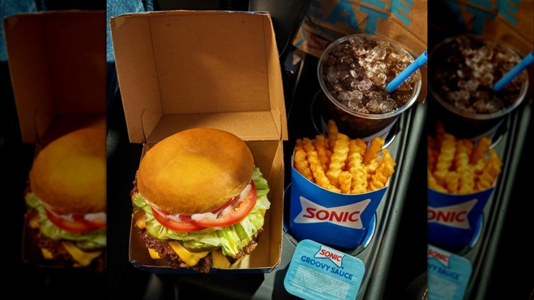 A sonic burger with fries and a drink from the drive thru