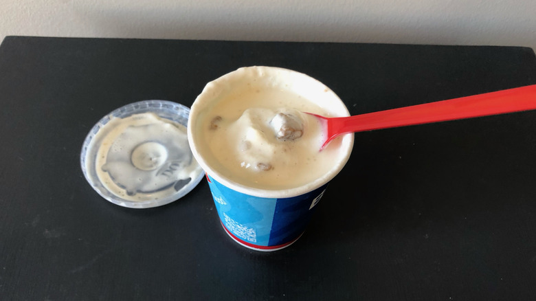 Dairy Queen caramel toffee cookie Blizzard with red spoon.