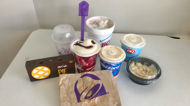 8 different fast-food fall desserts set on white table.
