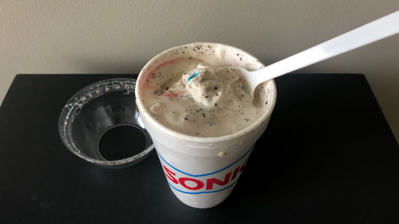 SONIC Vanilla Trick or Treat Blast with long white spoon.