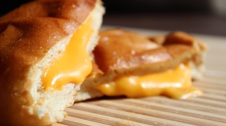 Close-up of soft bread roll stuffed with melty cheese