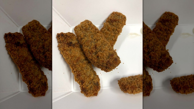 Breaded steak fingers in white cardboard tray