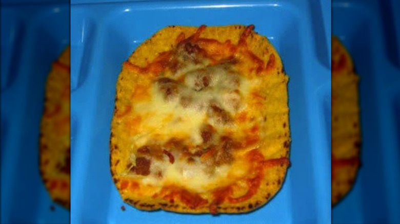 Cheesy taco boat on blue tray