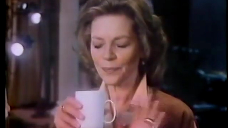screen capture from one of Lauren Bacall's iconic High Point coffee commercials, showing the actress holding a white cup of coffee with an expression of appreciation