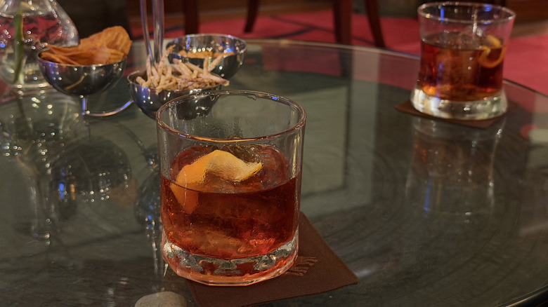 cocktail with tequila, grenadine and lemon zest garnish