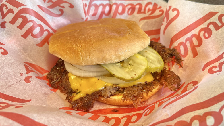 Single Steakburger on a paper wrapper
