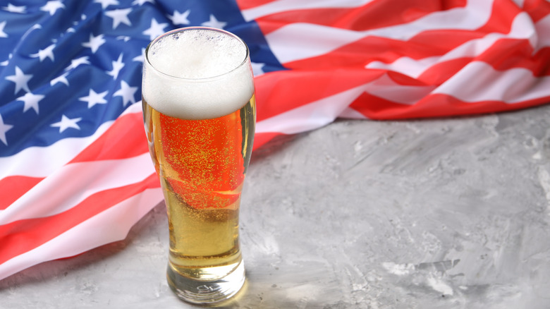 Glass of beer on marble-looking surface with American flag