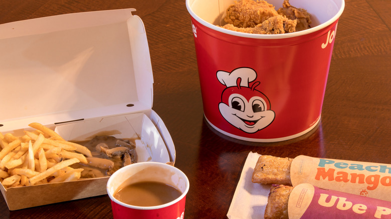 Jollibee fries, gravy, chicken, and pies on table