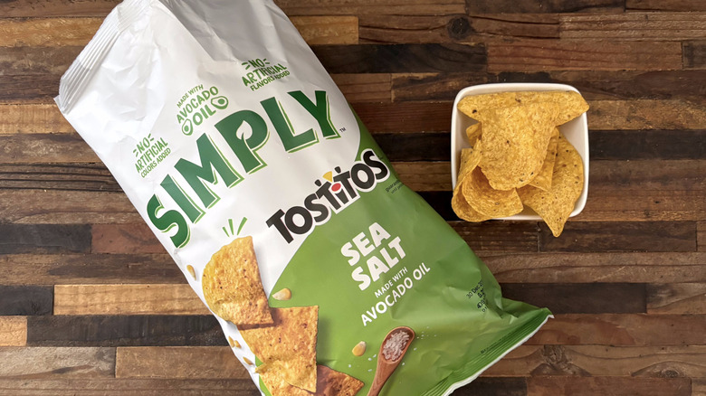 Tostitos Simply Tortilla Chips Sea Salt in bag and white bowl on wooden table
