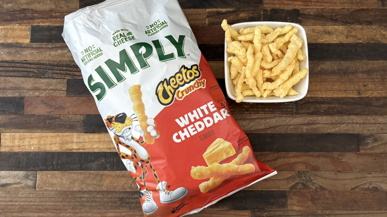 Simply Cheetos Crunchy White Cheddar in bag and white bowl on wooden table