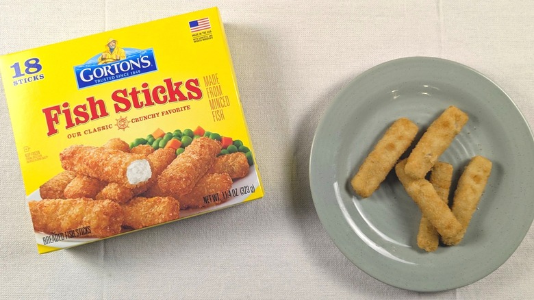 A plate of fish sticks next to a box of Gorton's fish sticks