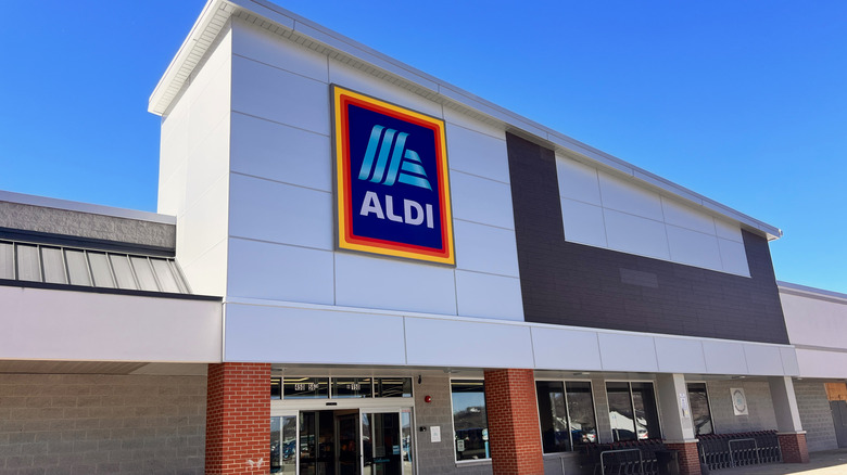 Aldi store with sign against blue sky