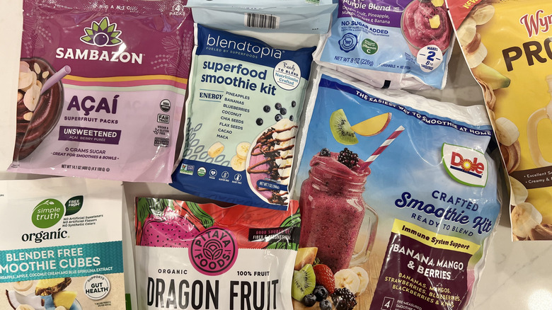 Different varieties of frozen smoothie mixes in bags.