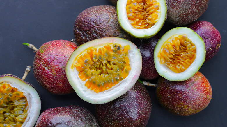 Pile of passion fruits with some cut in half